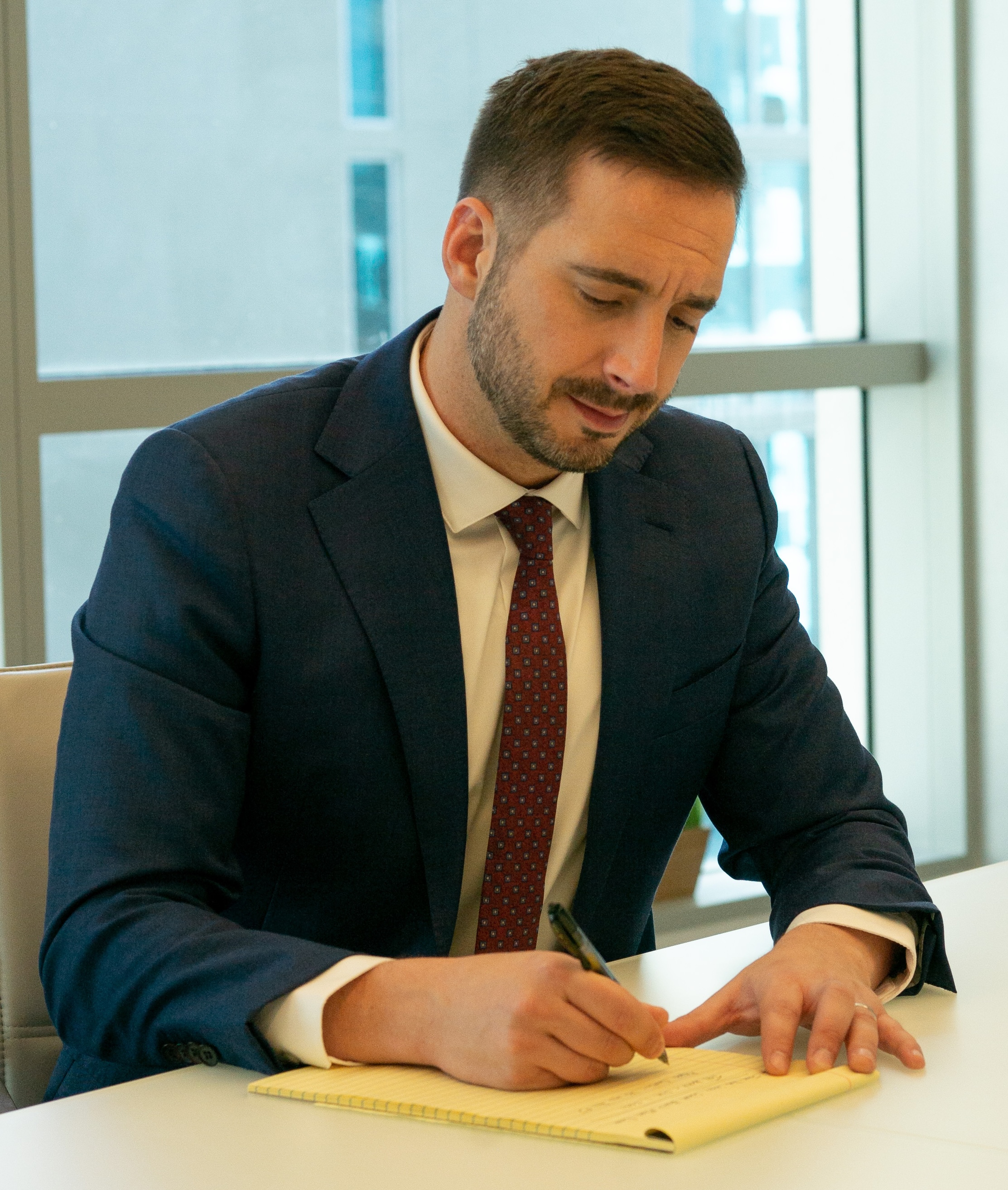 Mark Schweikert writing on a legal notepad